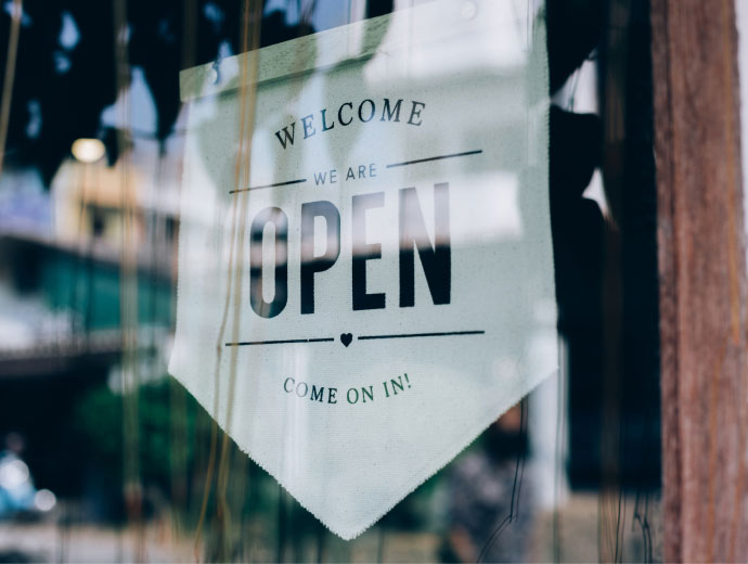 "Welcome we are open" hanging sign