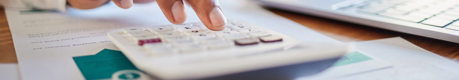 close-up of a hand using a calculator