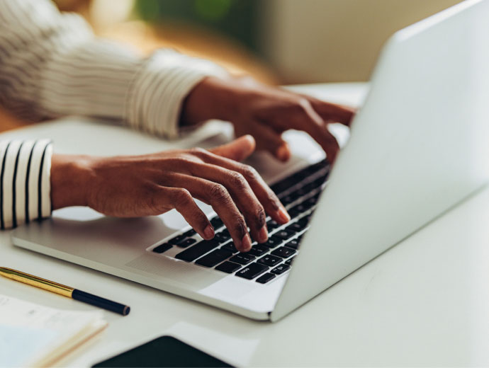 hands typing on a keyboard